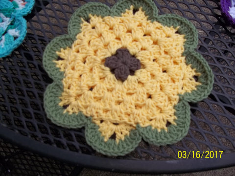 Brown/yellow/green pot holder, approx. 8" across